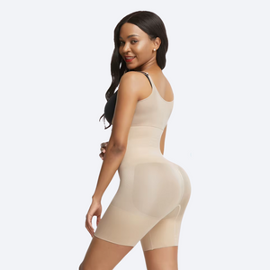 Woman wearing a beige shapewear dress on a white background