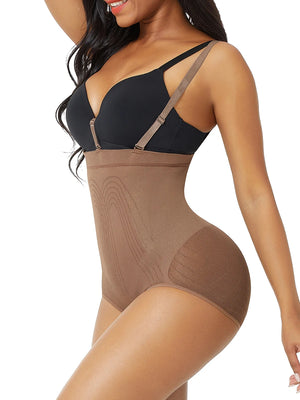 Woman wearing a black bra and brown shapewear on a white background