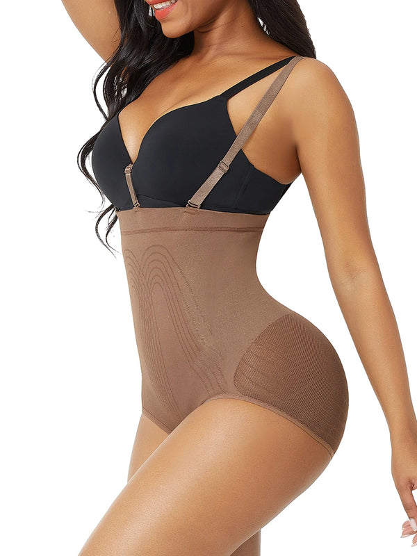 Woman wearing a black bra and brown shapewear on a white background