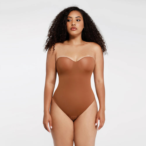 Woman wearing a brown bodysuit against a white background