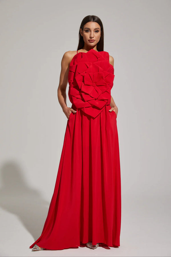 Woman wearing a red evening gown against a plain background