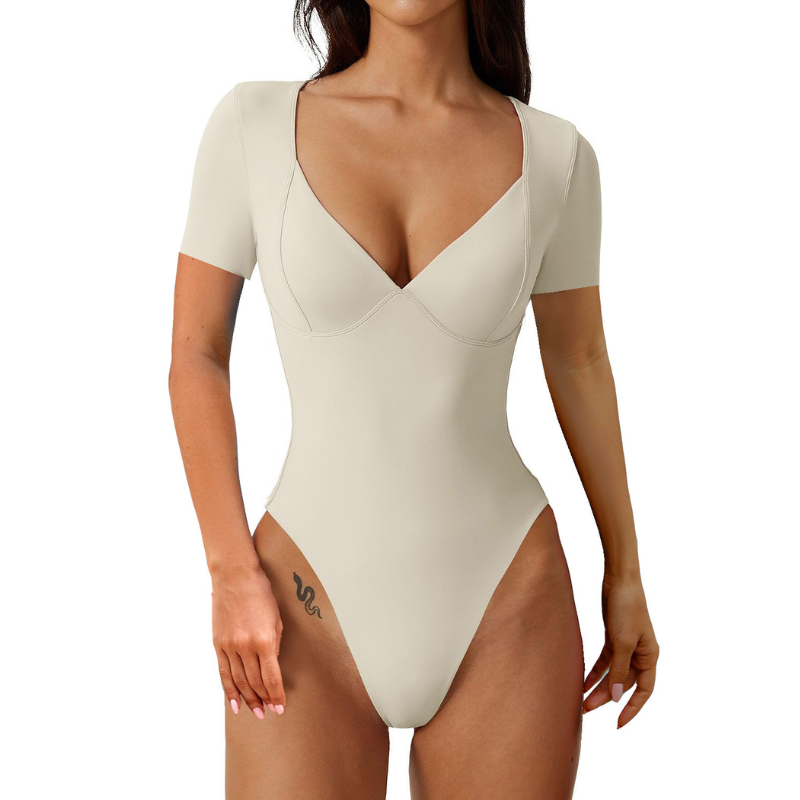 The Short Sleeve V-Neck Bodysuit, is a chic and versatile piece designed to make you feel effortlessly stylish. Its streamlined silhouette and gently seamed cups off
