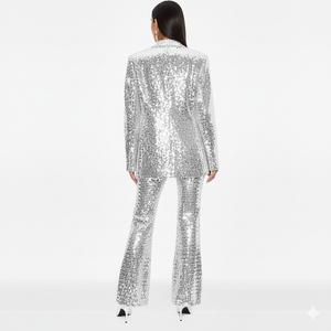 Person wearing a silver sequin suit on a white background