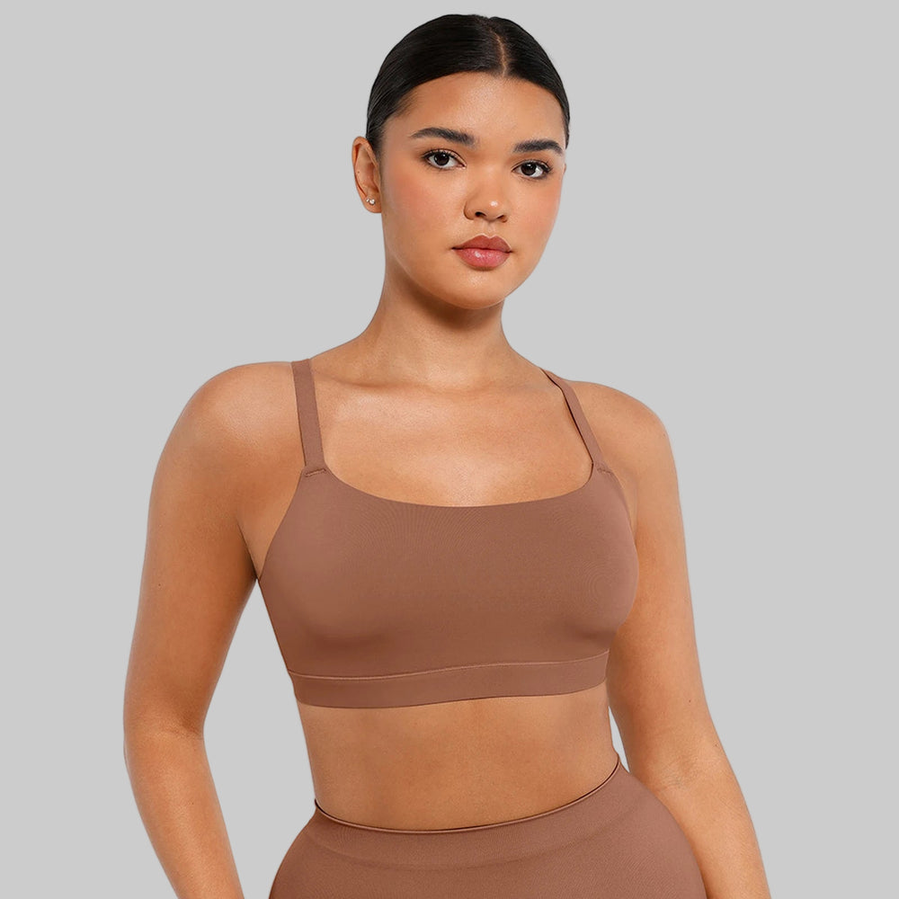 Woman wearing a brown sports bra and leggings