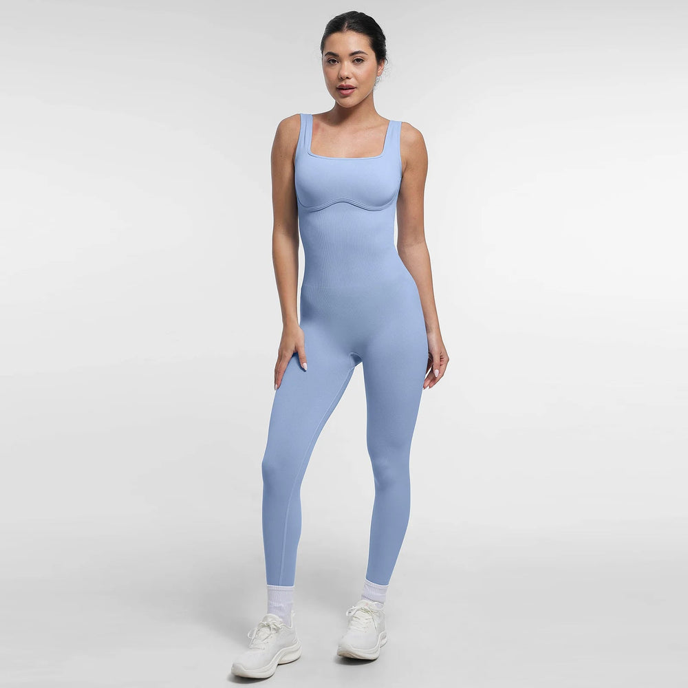 Woman wearing a light blue jumpsuit on a white background