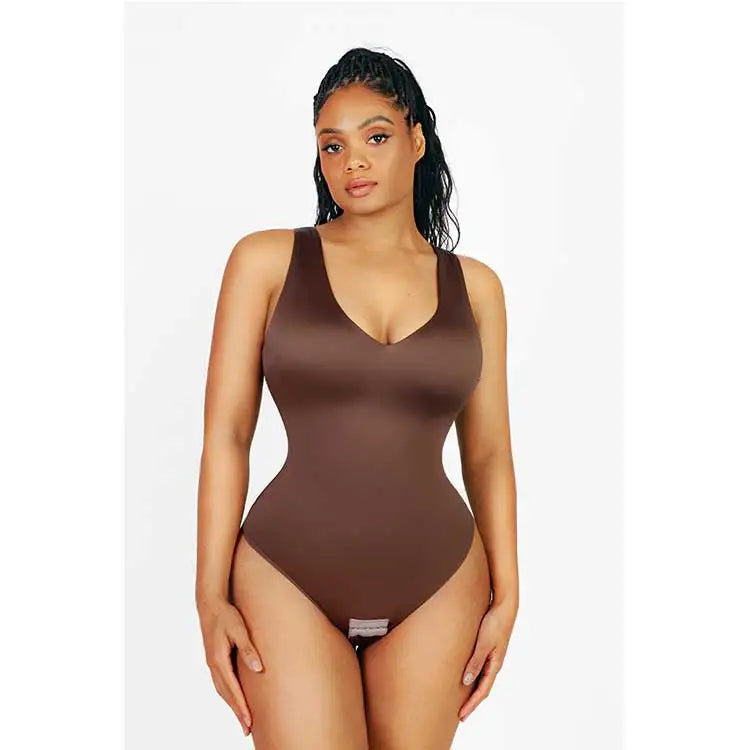 Woman wearing a brown swimsuit against a white background
