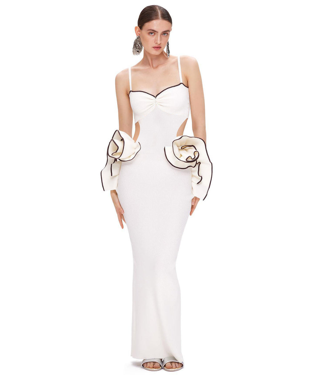 White evening gown with cut-out design and large gloves on a white background