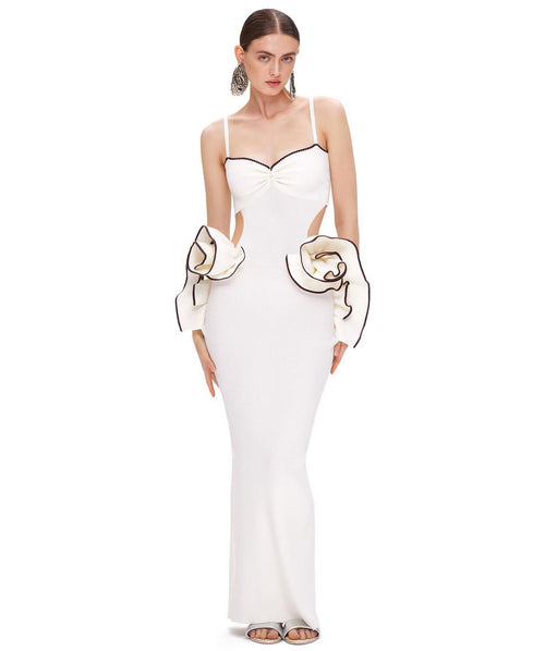 White evening gown with cut-out design and large gloves on a white background