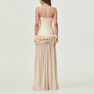 Beige strapless gown with floral details on a plain background