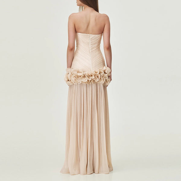 Beige strapless gown with floral details on a plain background