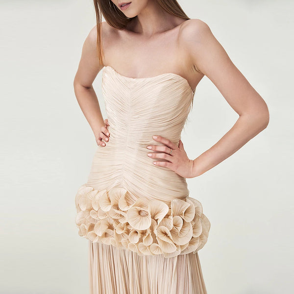 Beige strapless dress with floral details on a plain background