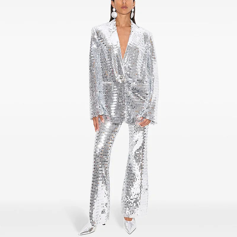 Person wearing a silver sequin suit on a white background