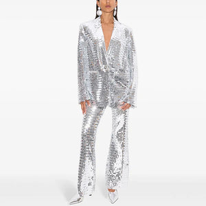 Person wearing a silver sequin suit on a white background