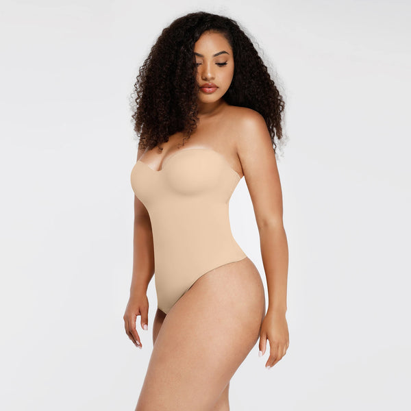 Woman wearing a beige strapless bodysuit on a white background