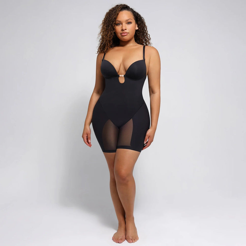 Woman wearing a black shapewear bodysuit on a gray background