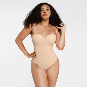 Woman wearing a beige bodysuit against a white background