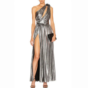 Silver metallic halter neck gown with a high slit on a white background