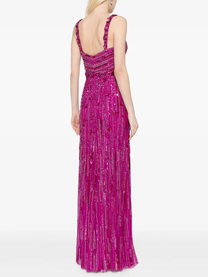 Woman wearing a pink beaded evening gown on a white background