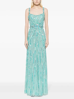 Woman wearing a light blue beaded evening gown on a white background