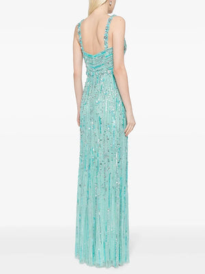 Mint green beaded evening gown on a white background