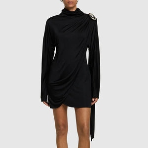 Black dress with long sleeves and a unique shoulder detail on a white background