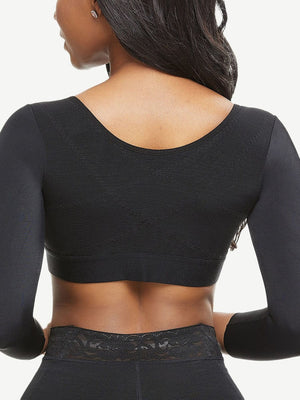 Black long-sleeve athletic top worn by a person on a white background