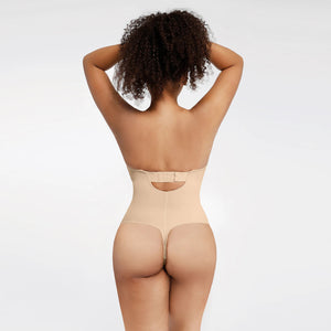 Person wearing a beige shapewear garment on a plain background
