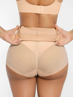 Beige shapewear being worn on a plain background