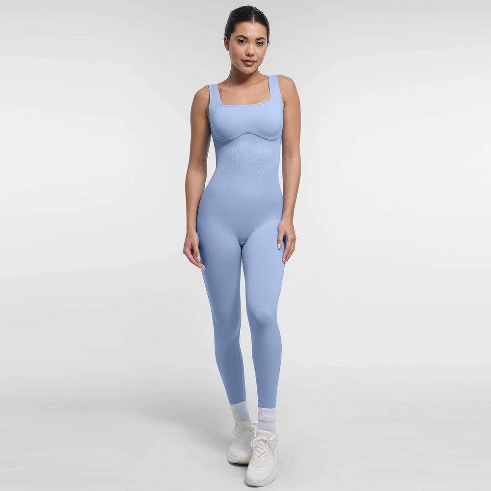 Woman wearing a light blue jumpsuit on a white background