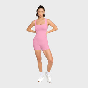 Woman wearing a pink bodysuit on a white background